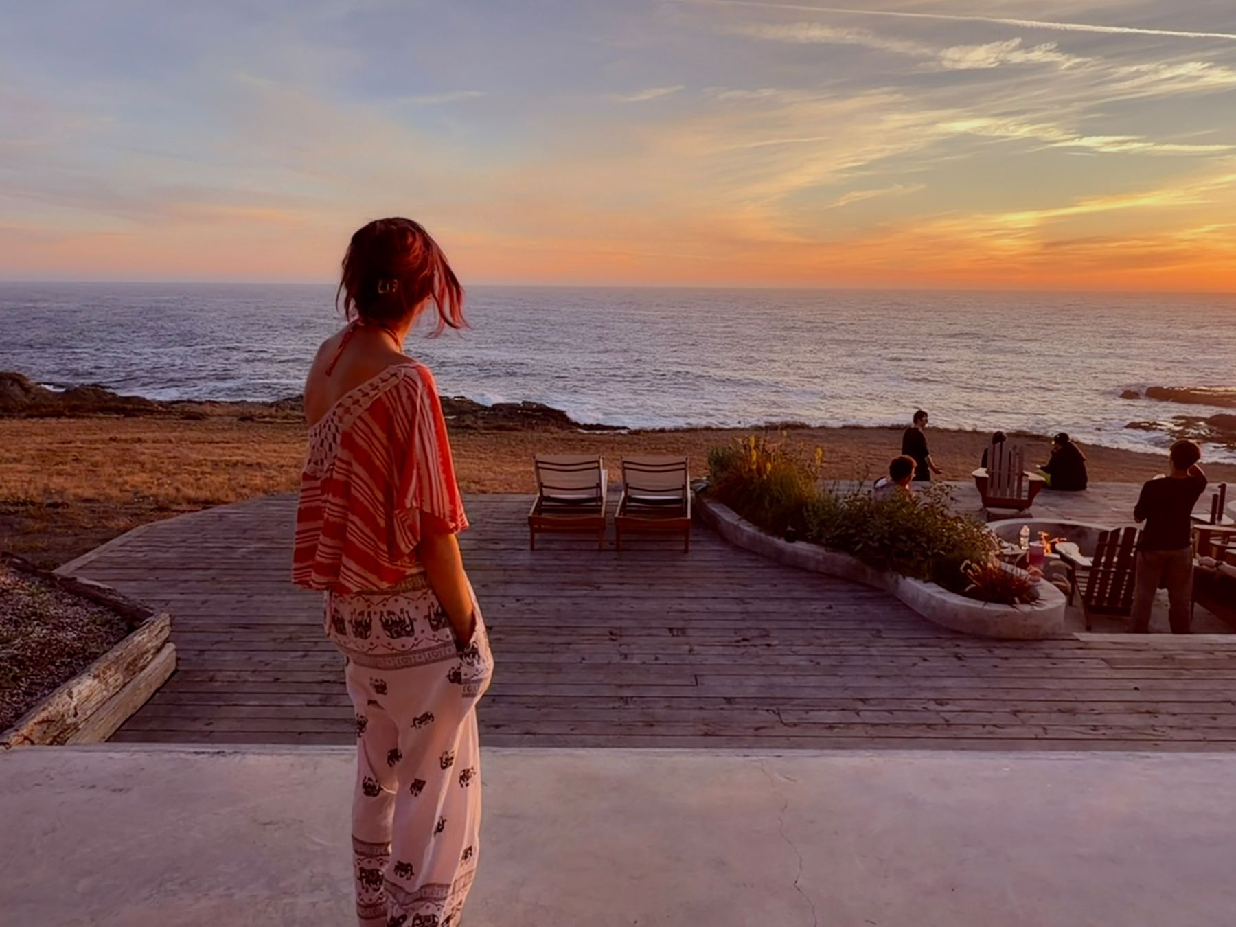 Guest watching the sunset from the oceanfront deck